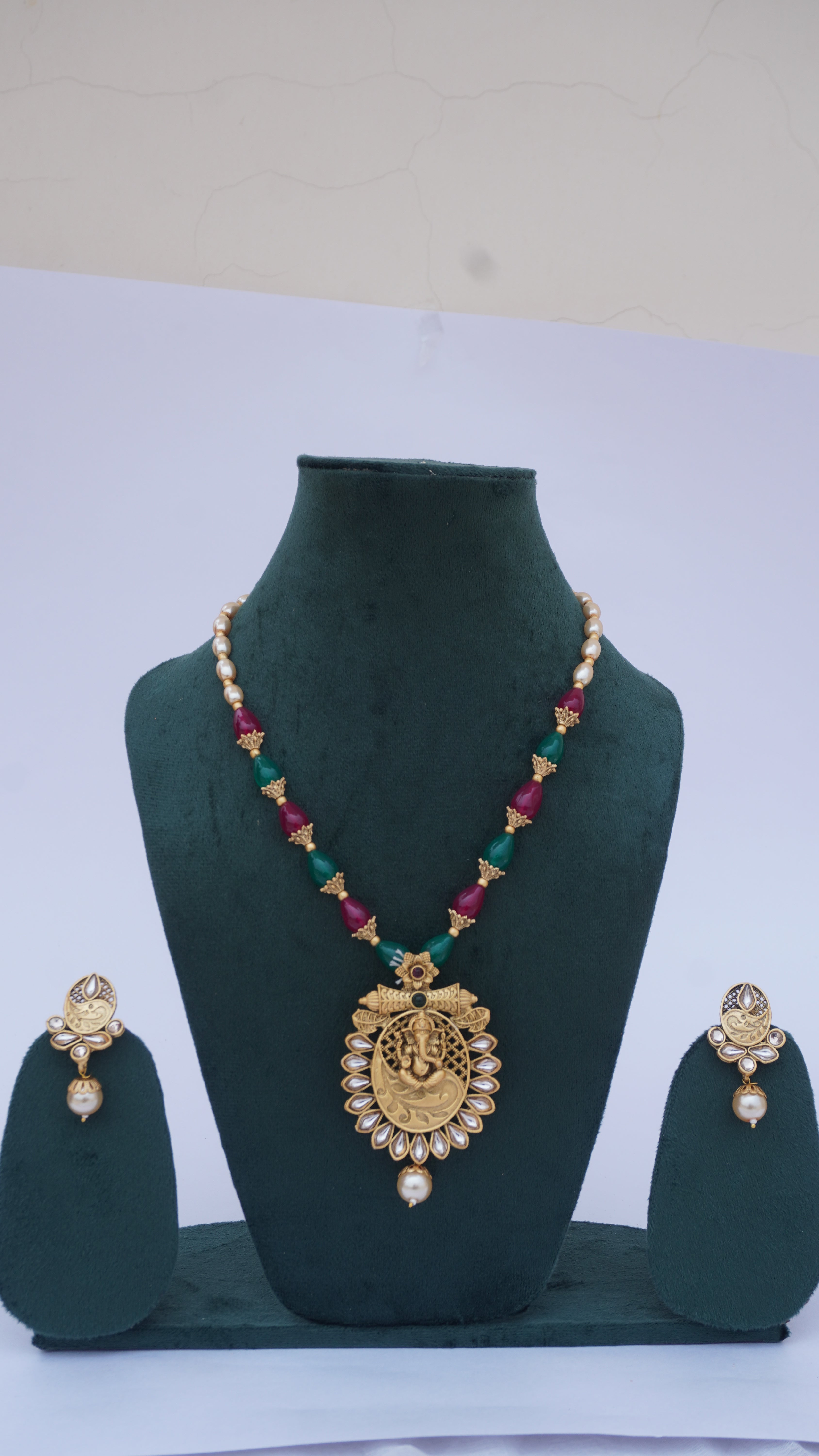 Traditional Ganesha Temple Necklace Set with Kundan Work and Pearl Drops – Red & Green Beads – Ashthi Jewels