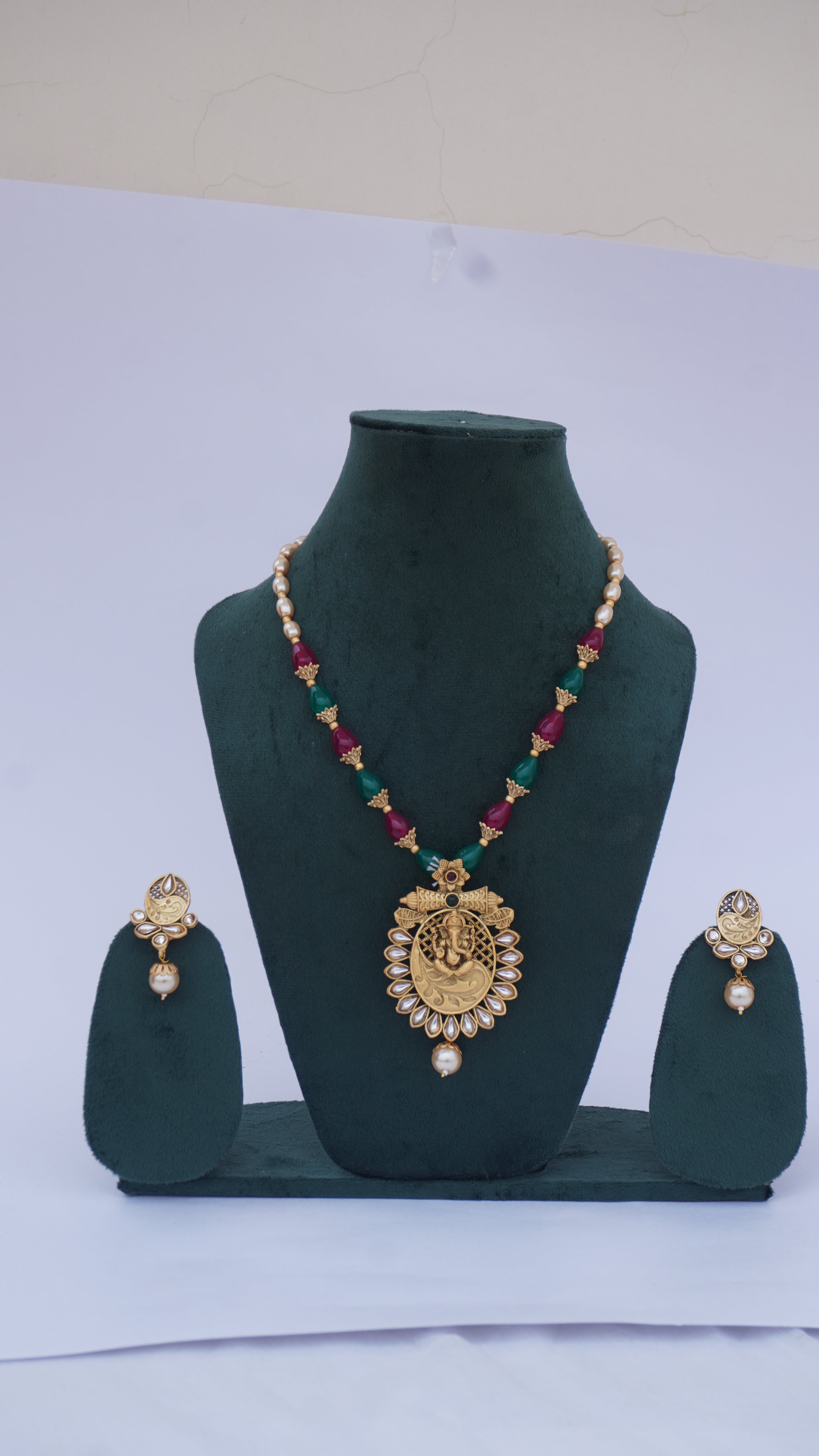 Traditional Ganesha Temple Necklace Set with Kundan Work and Pearl Drops – Red & Green Beads – Ashthi Jewels