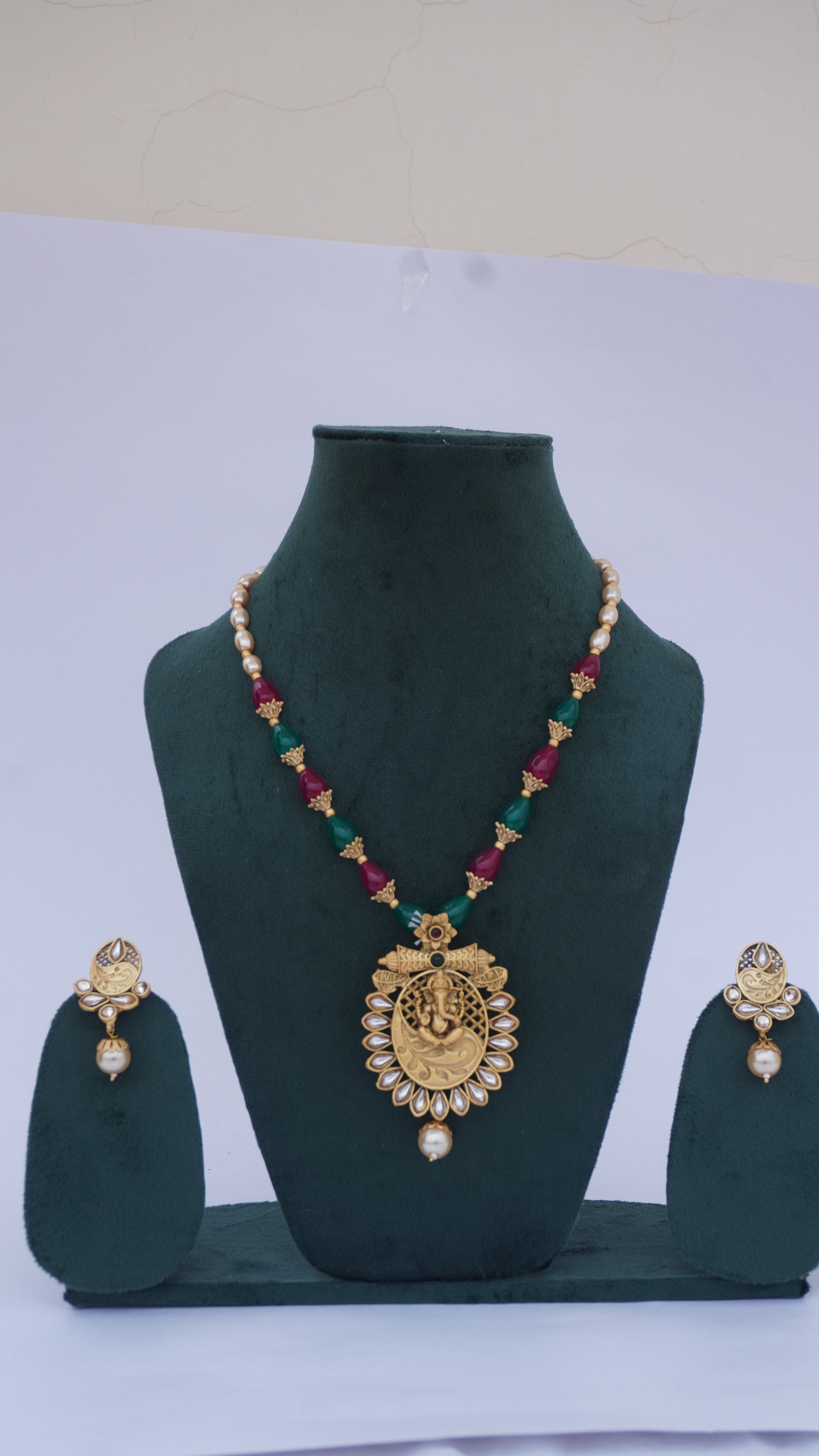 Traditional Ganesha Temple Necklace Set with Kundan Work and Pearl Drops – Red & Green Beads – Ashthi Jewels