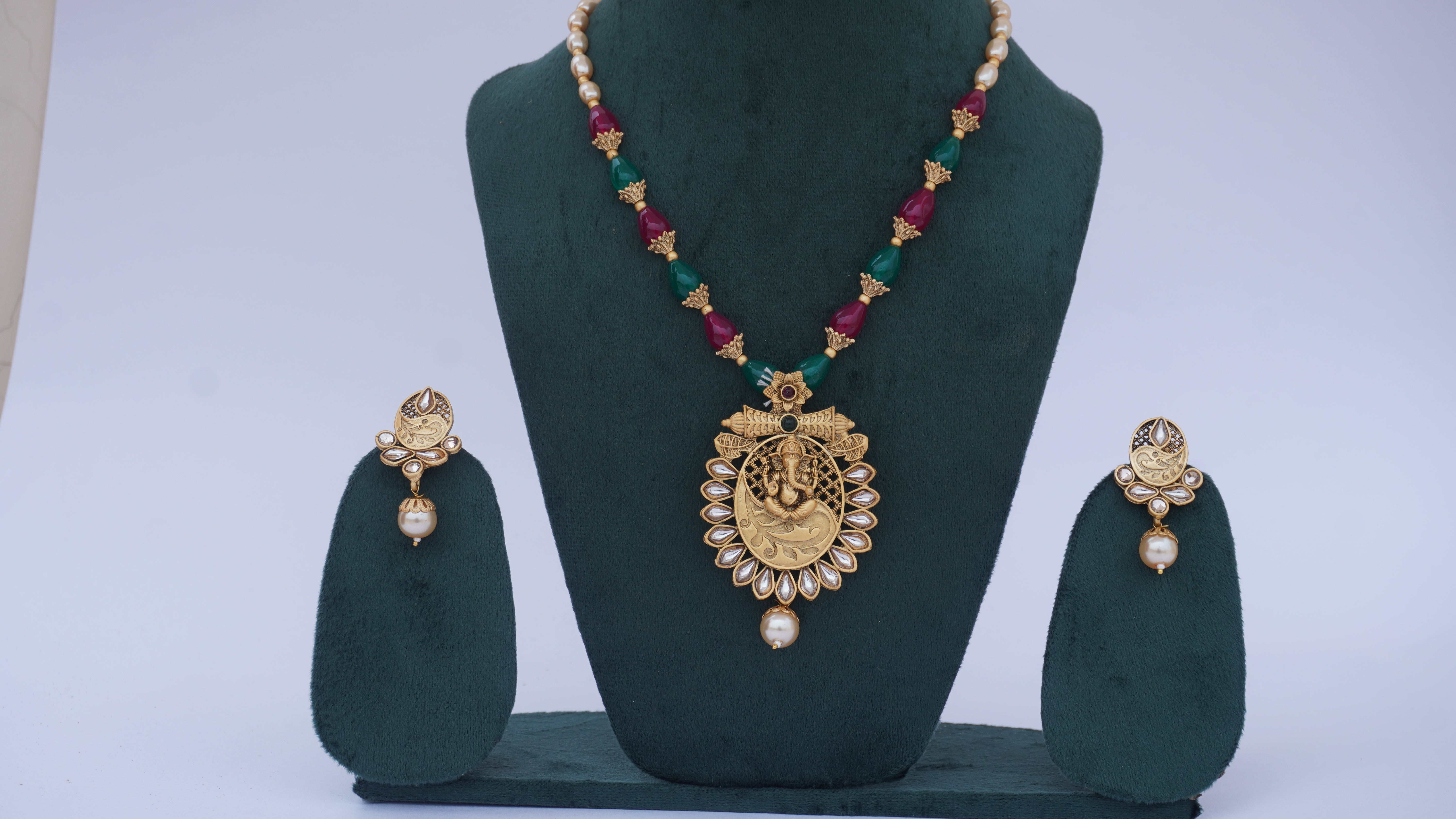 Traditional Ganesha Temple Necklace Set with Kundan Work and Pearl Drops – Red & Green Beads – Ashthi Jewels