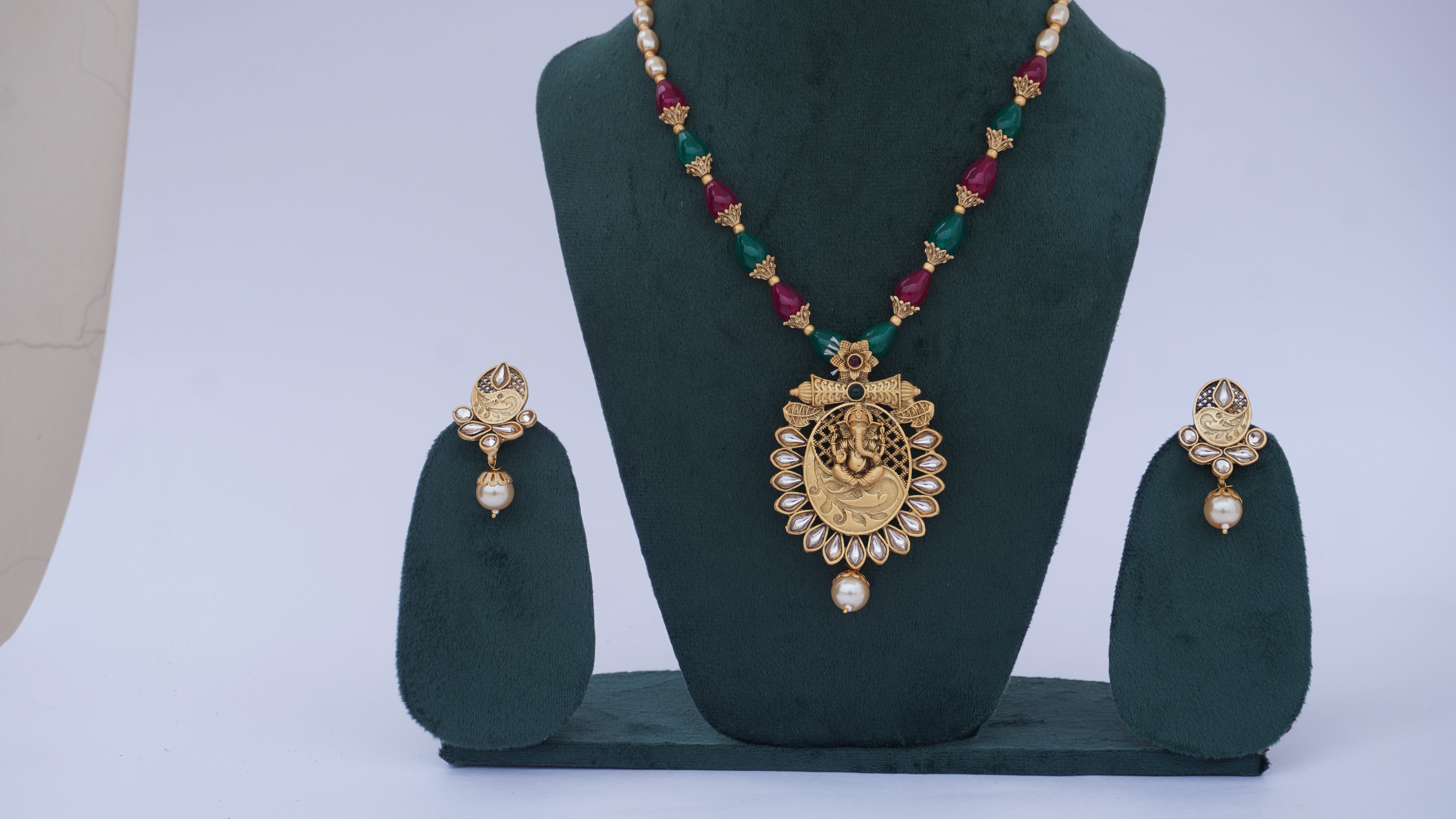 Traditional Ganesha Temple Necklace Set with Kundan Work and Pearl Drops – Red & Green Beads – Ashthi Jewels