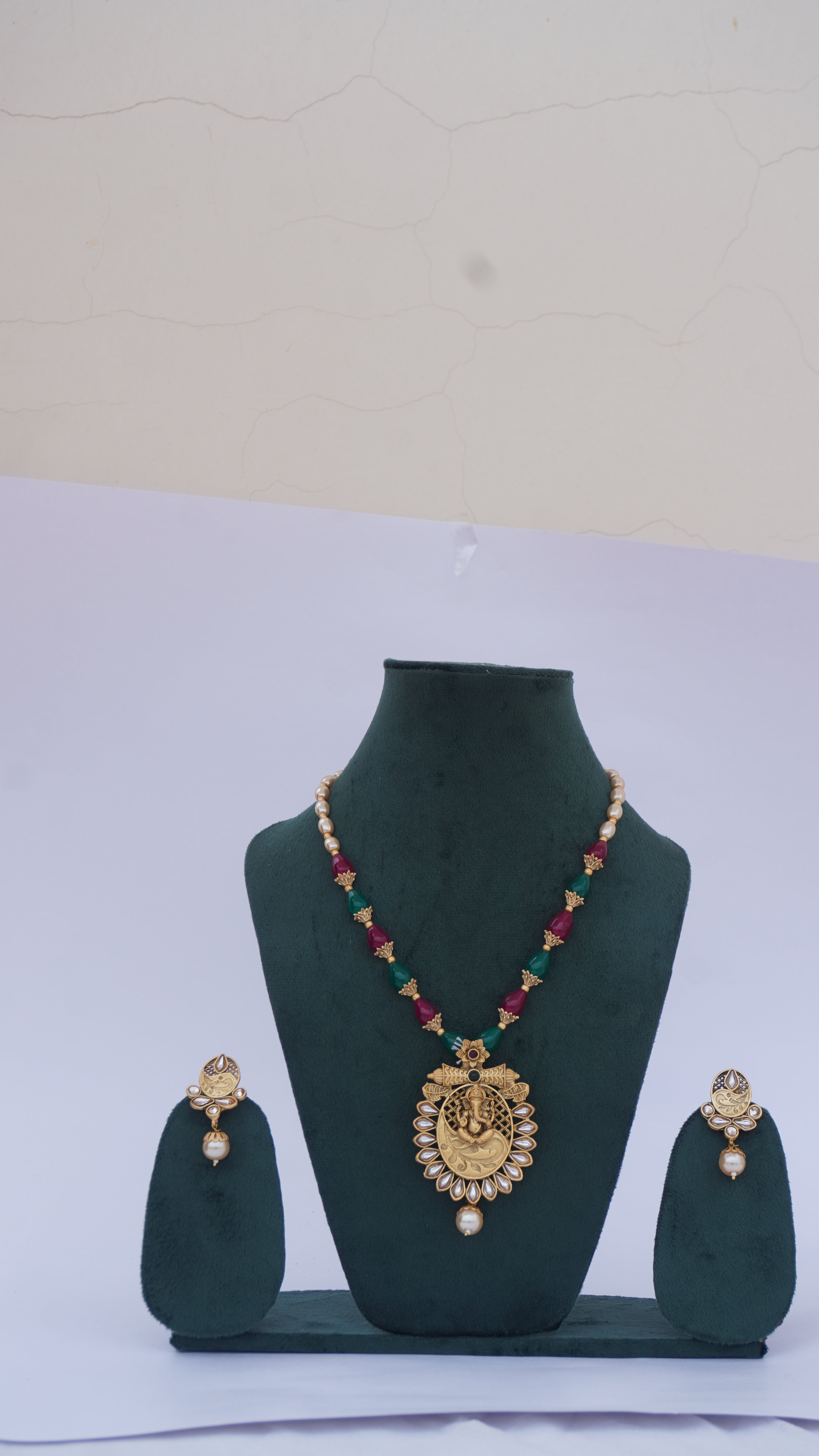 Traditional Ganesha Temple Necklace Set with Kundan Work and Pearl Drops – Red & Green Beads – Ashthi Jewels